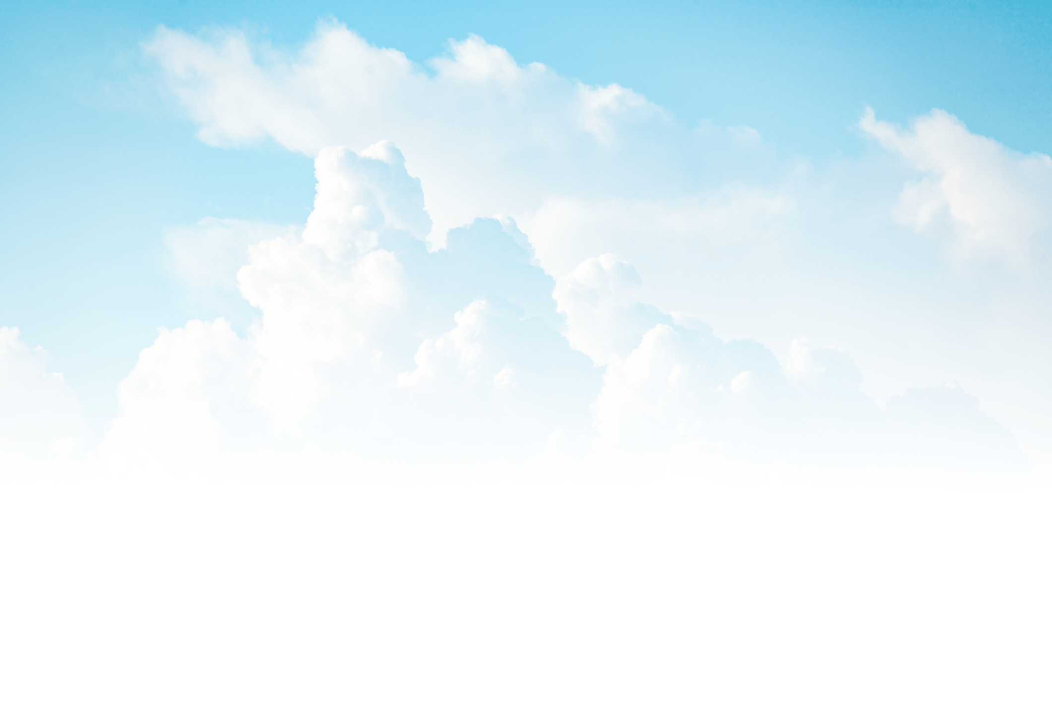 A clear blue sky with fluffy white clouds, creating a serene and peaceful atmosphere. No landmarks or people are visible.